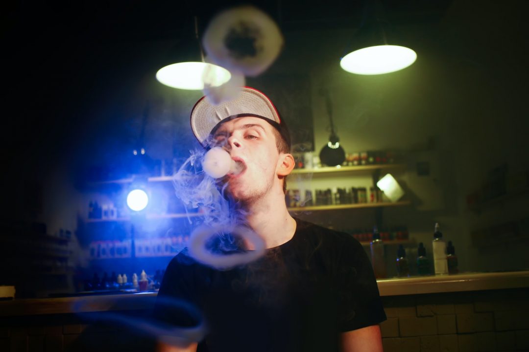 The man smoke an electronic cigarette at the vape shop